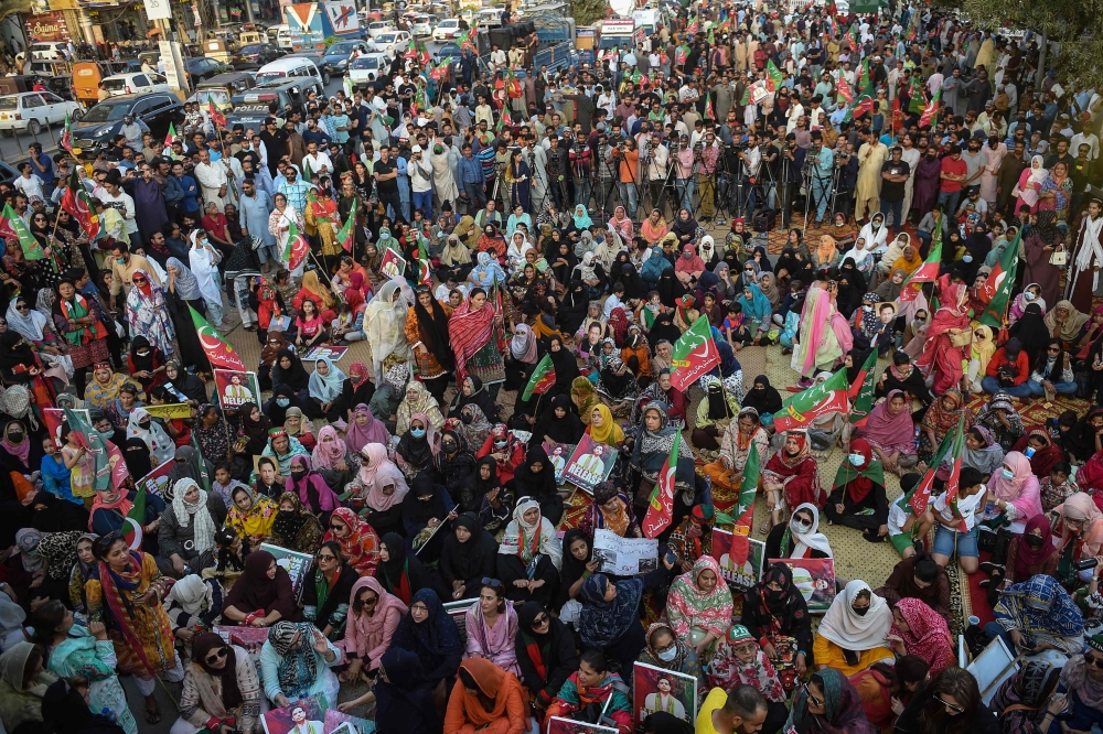 Supporters of Pakistan's former prime minister Imran Khan, gather during a protest in Karachi on March 19, 2023, demanding release of arrested party workers in recent police clashes. (Photo by Rizwan Tabassum / AFP)