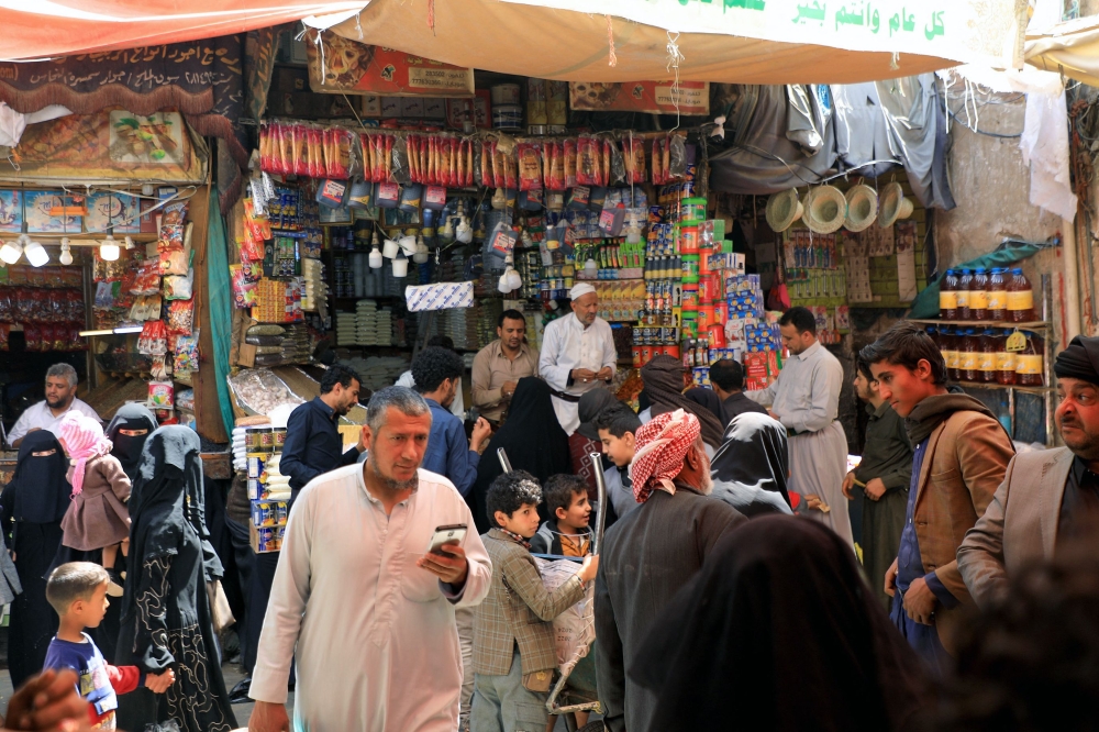 People gather at a market in Sanaa on March 18, 2023, ahead of the Muslim holy month of Ramadan. (Photo by Mohammed HUWAIS / AFP)