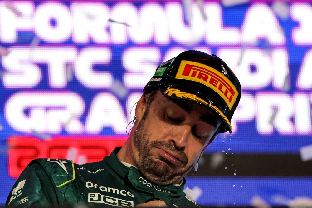 Aston Martin's Spanish driver Fernando Alonso reacts on the podium at the end of the Saudi Arabia Formula One Grand Prix at the Jeddah Corniche Circuit in Jeddah on March 19, 2023. Photo by Giuseppe CACACE / AFP
