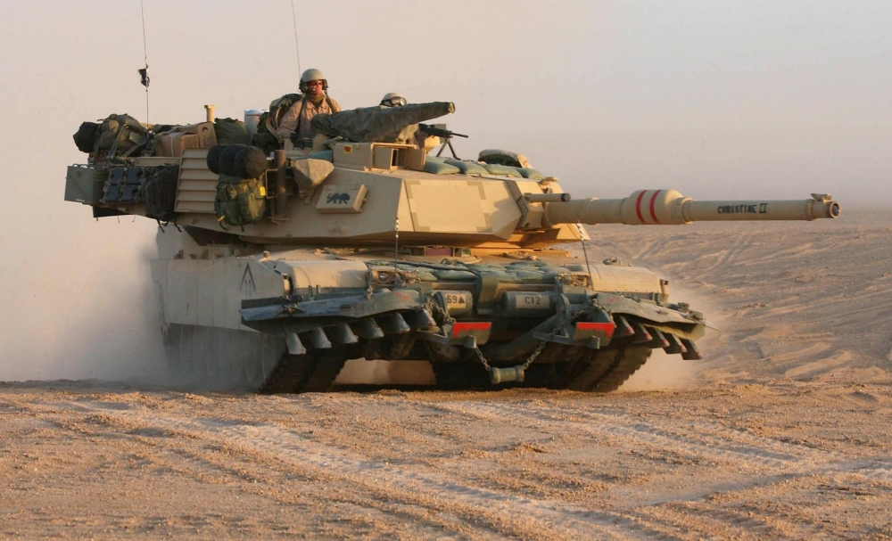 In this photograph taken on March 18, 2003 a US M1A1 Abrams tank from the US Army 3rd Infantry Division in the northern Kuwait desert advances close to Iraq. - The United States will deliver Abrams tanks to Ukraine by the fall of 2023 -- significantly faster than expected -- while Patriot air defenses will also arrive on an 
