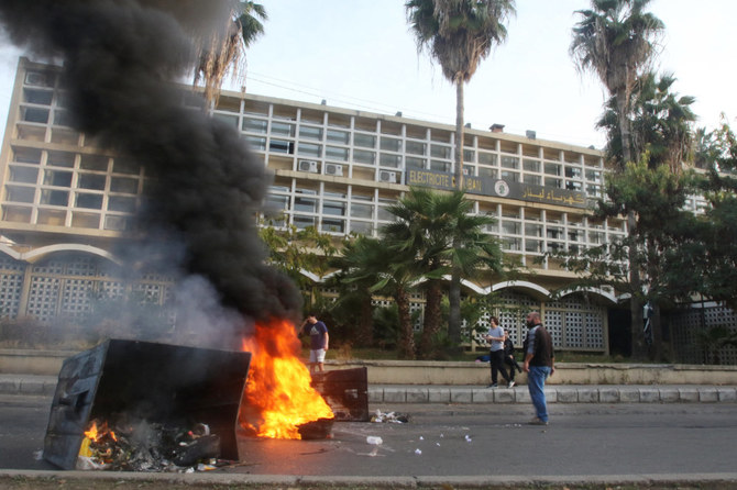 File Photo: Lebanese demonstrators block a road with burning tyres in front of the Electricite Du Liban company building in the southern city of Sidon, as the country struggles with a deep economic crisis. (AFP)