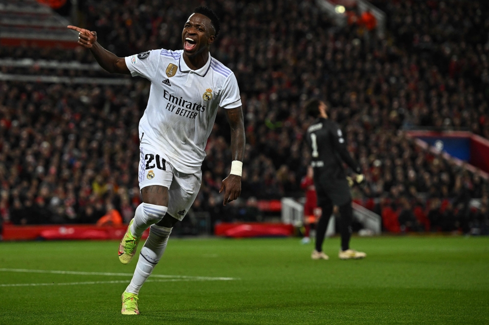 Real Madrid's Brazilian forward Vinicius Junior celebrates scoring the team's second goal during the UEFA Champions League last 16 first leg football match between Liverpool and Real Madrid at Anfield in Liverpool, north west England on February 21, 2023. (Photo by Paul Ellis / AFP)