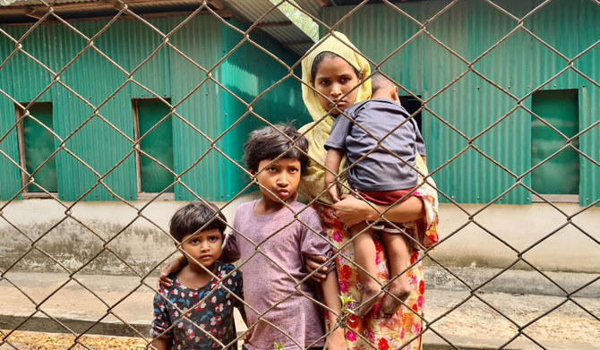 A Rohingya family arrives for a meeting with the Myanmar officials in Teknaf on March 19, 2023. (AFP)
