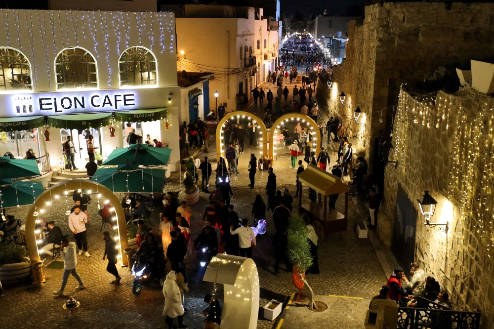 People gather at a decorated area in Tripoli on the first day of the Islamic holy month of Ramadan, in Libya on March 23, 2023. (Photo by Mahmud Turkia / AFP)