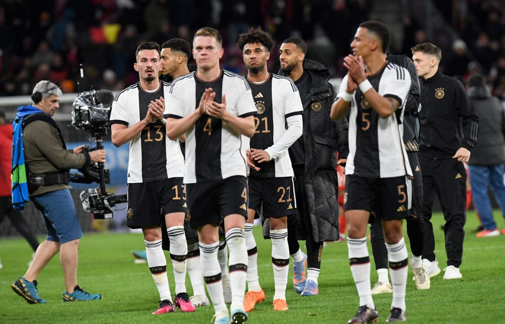 Germany's players applaud the fans after the international friendly football match Germany v Peru in Mainz, southern Germany, on March 25, 2023. Photo by Thomas KIENZLE / AFP
