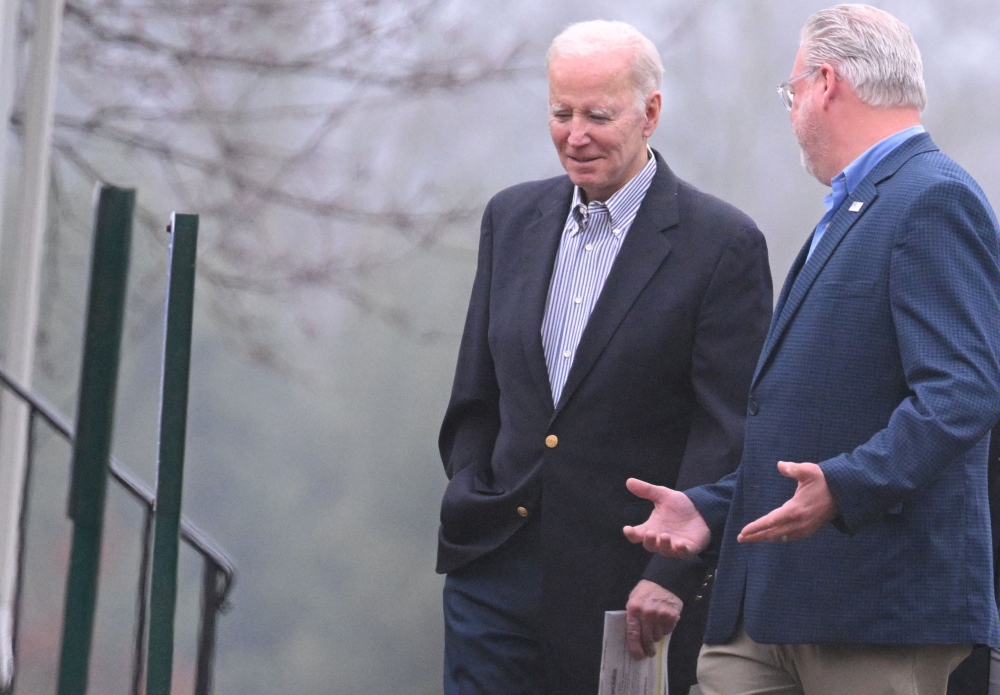US President Joe Biden (left) speaks with another congregant on the walk back to the motorcade as he departs from Saint Joseph on the Brandywine Roman Catholic Church in Wilmington, Delaware on March 25, 2023. (Photo by Mandel NGAN / AFP)
