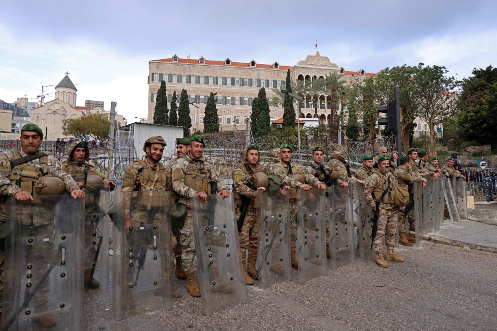 Soldiers stand guard outside the government palace during a demonstration by retired Lebanese army and security forces veterans demanding inflation-adjustments to their pensions, in Beirut on March 30, 2023. (Photo by JOSEPH EID / AFP)