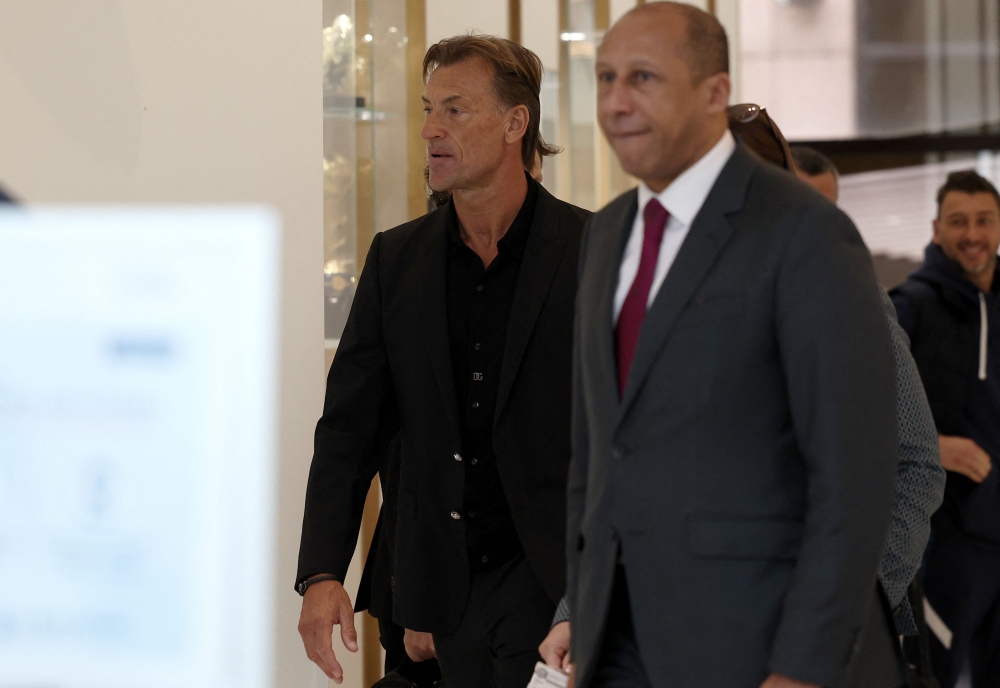 Former head coach of Saudi Arabia, French Herve Renard (L) and French Football Federation (FFF) Interim President Philippe Diallo arrive at the French Football Federation headquarters in Paris, on March 30, 2023. (Photo by FRANCK FIFE / AFP)