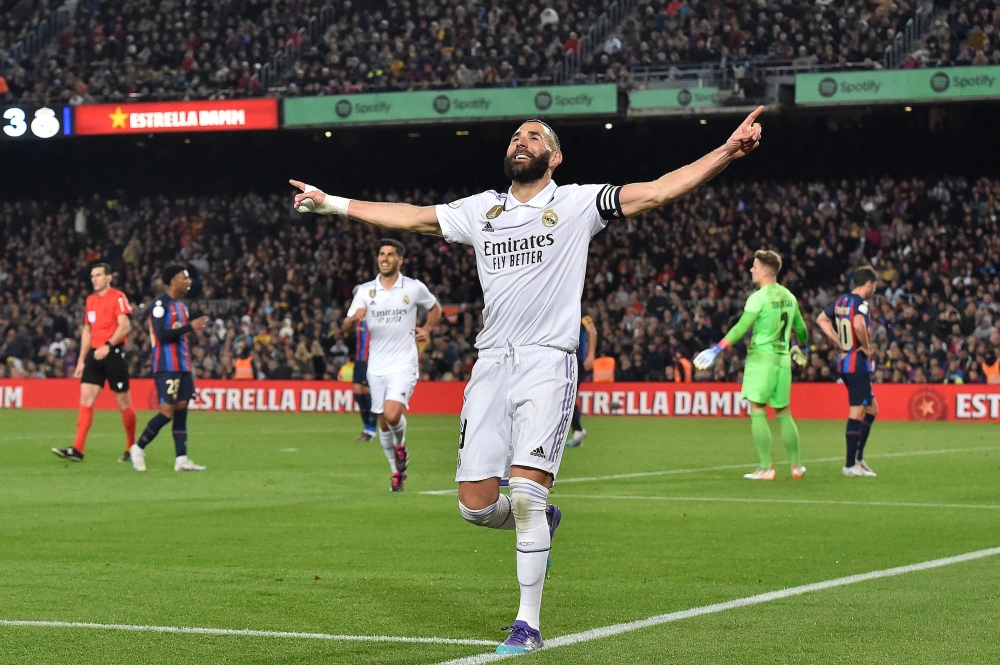 Real Madrid's French forward Karim Benzema celebrates after scoring his team's fourth goal during the Copa del Rey (King's Cup) semi-final second leg football match between FC Barcelona and Real Madrid CF at the Camp Nou stadium in Barcelona on April 5, 2023. Photo by Pau BARRENA / AFP