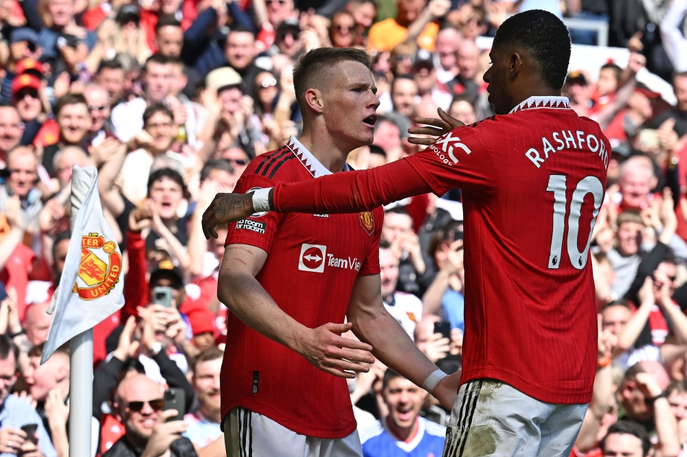 Manchester United's Scottish midfielder Scott McTominay (L) celebrates scoring the opening goal with Manchester United's English striker Marcus Rashford during the English Premier League football match between Manchester United and Everton at Old Trafford in Manchester, north west England, on April 8, 2023. (Photo by Paul ELLIS / AFP) 
