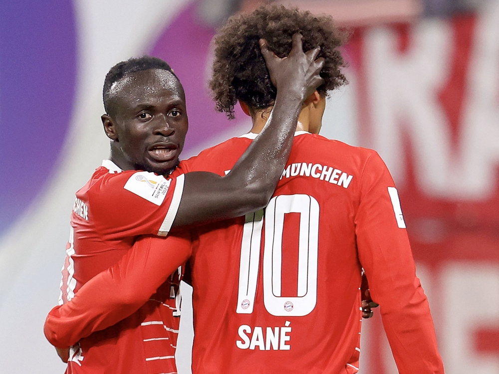 In this file photo taken on July 30, 2022 Bayern Munich's German midfielder Leroy Sane (right) celebrates scoring the 5-3 lead with Bayern Munich's Senegalese forward Sadio Mane during the German Supercup football match between RB Leipzig and FC Bayern Munich in Leipzig. (Photo by Ronny Hartmann / AFP)