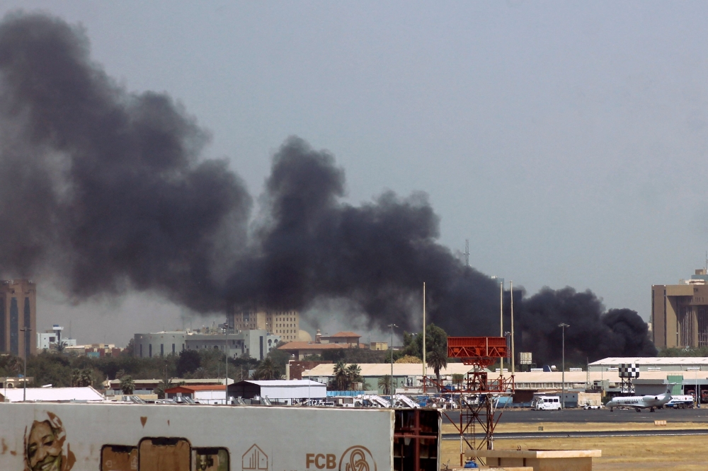 Heavy smoke bellows above buildings in the vicinity of the Khartoum airport on April 15, 2023, amid clashes in the Sudanese capital. Photo by AFP
