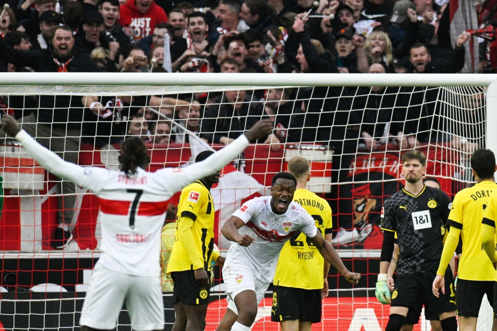 Stuttgart's Congolese midfielder Silas (C) celebrates after scoring the 2-2 equalizing goal during the German first division Bundesliga football match between VfB Stuttgart and Borussia Dortmund in Stuttgart, southwestern Germany on April 15, 2023. (Photo by THOMAS KIENZLE / AFP)
