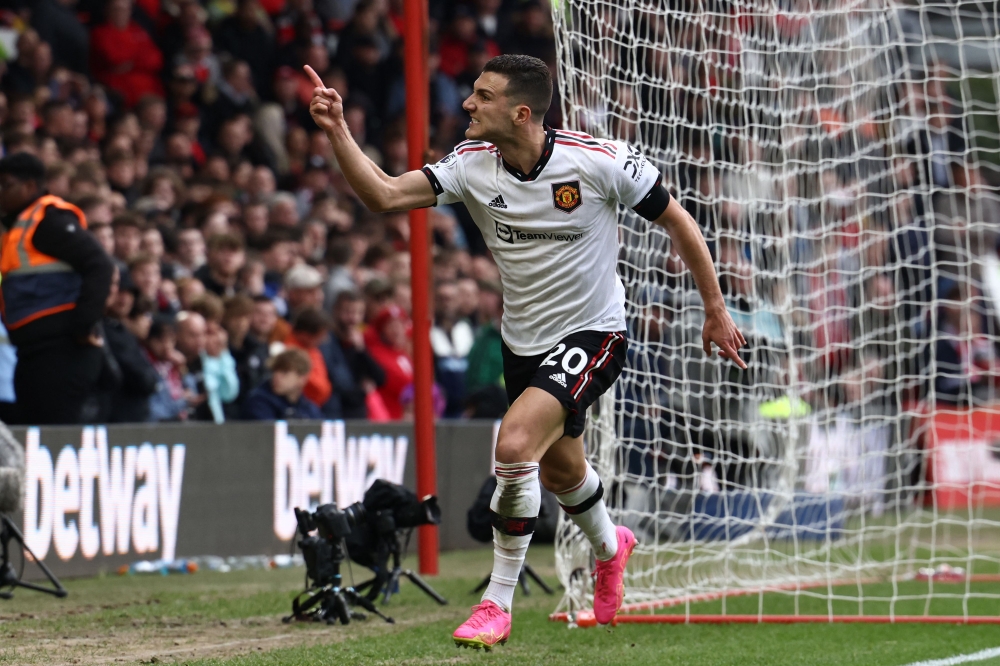 Manchester United's Portuguese defender Diogo Dalot celebrates after scoring their second goal during the English Premier League football match between Nottingham Forest and Manchester United at The City Ground in Nottingham, central England, on April 16, 2023. (Photo by DARREN STAPLES / AFP) 