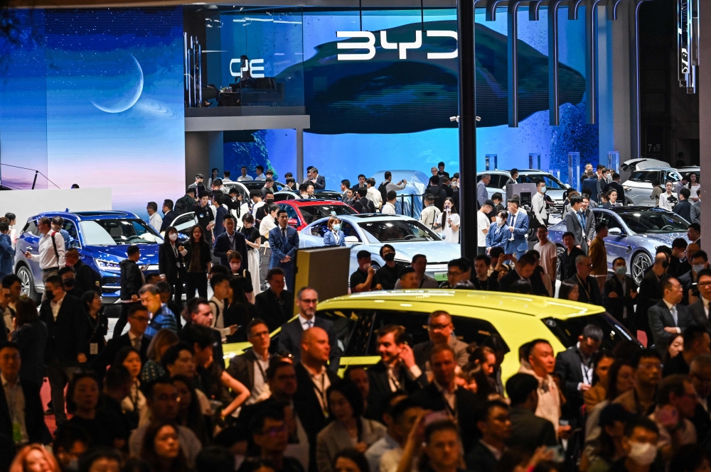 People look around the 20th Shanghai International Automobile Industry Exhibition in Shanghai on April 18, 2023. Photo by Hector RETAMAL / AFP