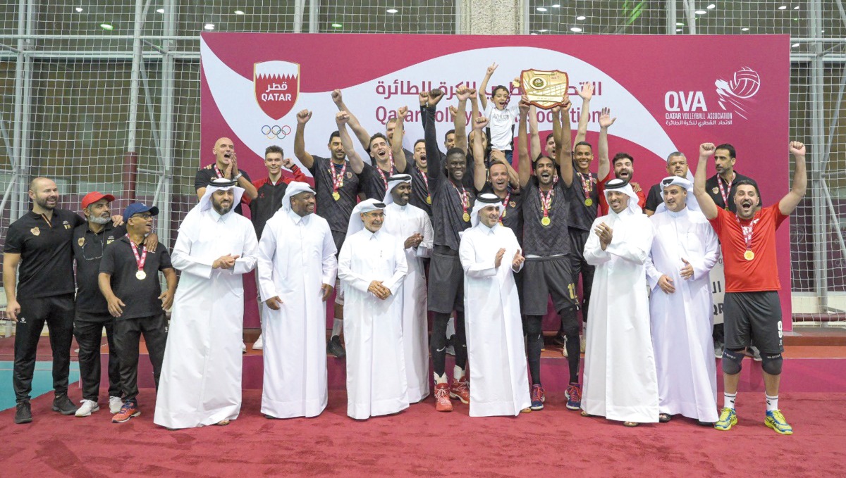 Al Rayyan players and officials celebrate after receiving the League championship trophy from President of the Qatar and West Asia Volleyball Associations Ali Ghanem Al Kuwari.