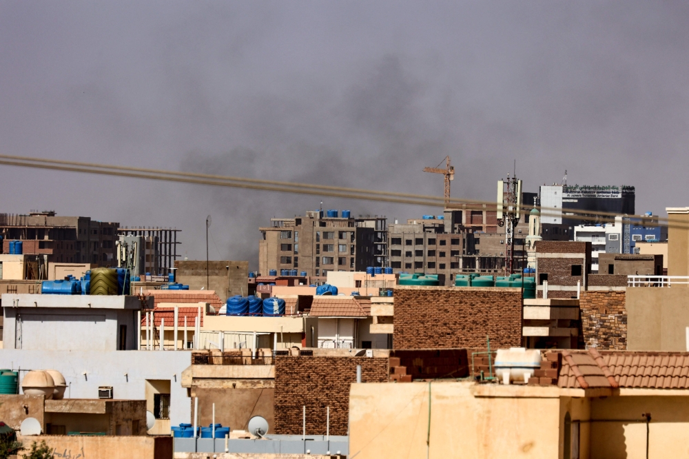 Smoke billows over residential buildings in eastern Khartoum on April 22, 2023, during ongoing battles between the forces of two rival generals. (Photo by AFP)