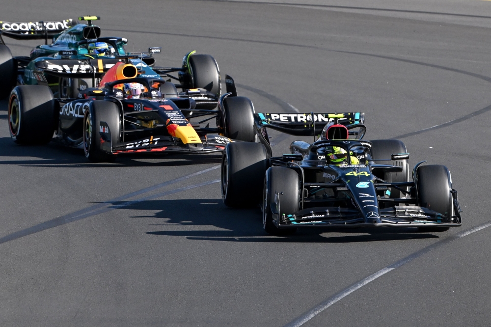 Mercedes' British driver Lewis Hamilton leads Red Bull Racing's Dutch driver Max Verstappen during the 2023 Formula One Australian Grand Prix at the Albert Park Circuit in Melbourne on April 2, 2023. Photo by WILLIAM WEST / AFP

