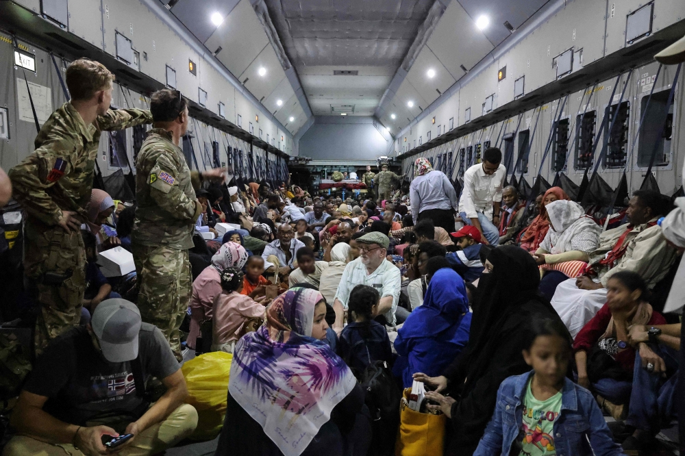 A handout picture released by the British Ministry of Defence (MOD) on April 27, 2023, and taken on April 26, shows British Nationals onboard an RAF aircraft in Sudan, during evacuation to Larnaca International Airport in Cyprus. (Photo by Arron Hoare / MOD / AFP)