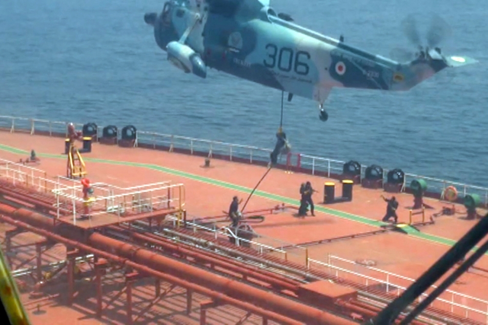 This grab taken from a video released by Iran's Army office on April 28, 2023, shows Iranian naval soldiers boarding the Advantage Sweet oil tanker off the coast of Oman. (Photo by Iranian Army office / AFP)