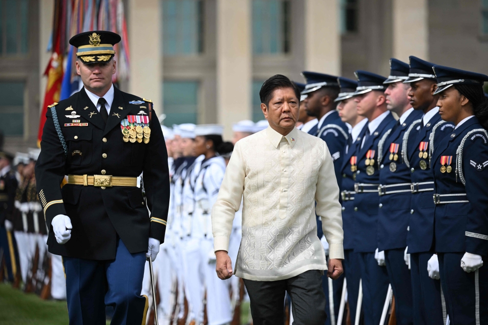 Philippines President Ferdinand Marcos, accompagned by Army colonel David Rowland, reviews the troops during a welcome ceremony outside of the Pentagon in Washington, DC on May 3, 2023. Photo by Mandel NGAN / AFP