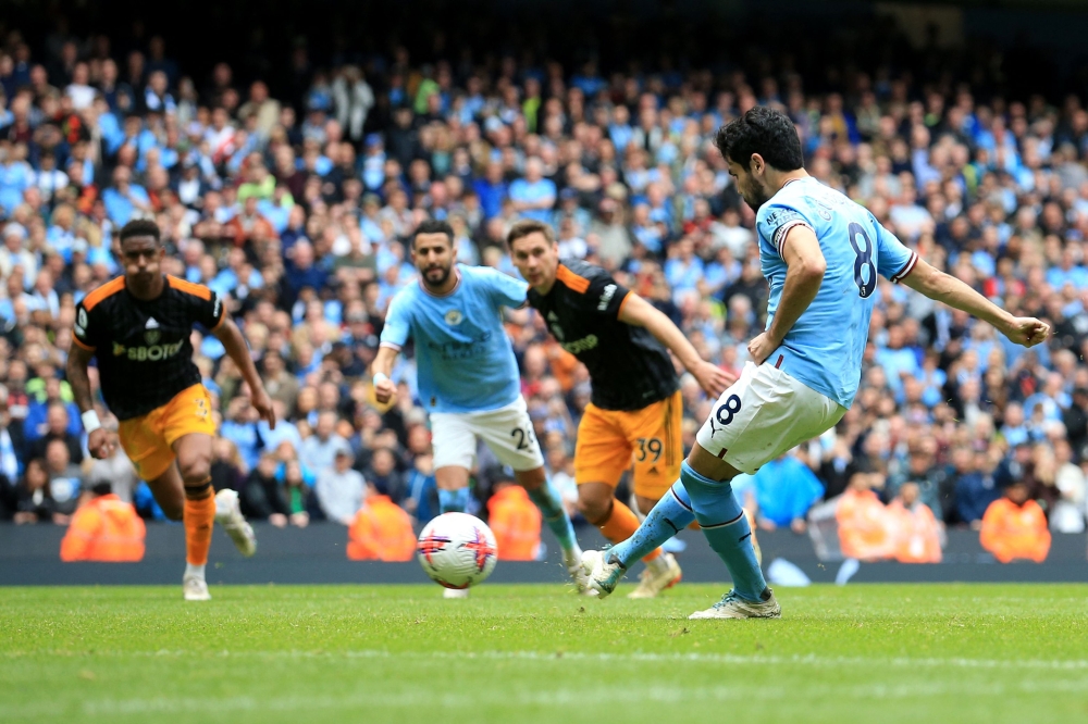 Manchester City's German midfielder Ilkay Gundogan (R) kicks and misses a penalty during the English Premier League football match between Manchester City and Leeds United at the Etihad Stadium in Manchester, north west England, on May 6, 2023. (Photo by Lindsey Parnaby / AFP)