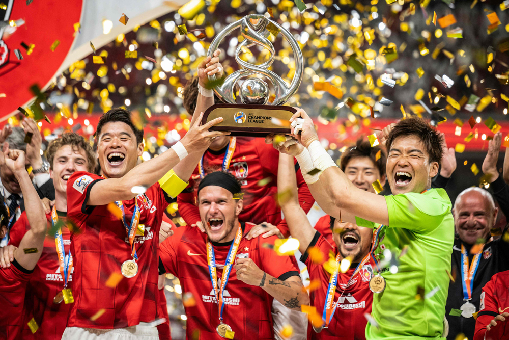 Urawa Red Diamonds players celebrate with the trophy after winning the AFC Champions League final against Al Hilal, yesterday. AFP
