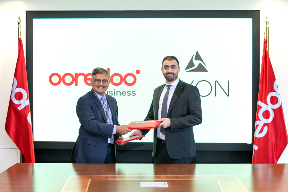 Ooredoo and Axon officials at the signing of the agreement.