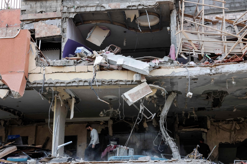 A damaged building is pictured after an Israeli airstrike in Gaza City, Palestininan Territories on May 9, 2023. (Photo by MOHAMMED ABED / AFP)