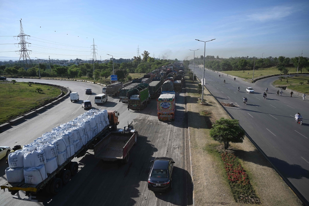 Trucks are seen stuck along a highway blocked during an ongoing protest in Islamabad on May 11, 2023. (Photo by Aamir Qureshi / AFP)
