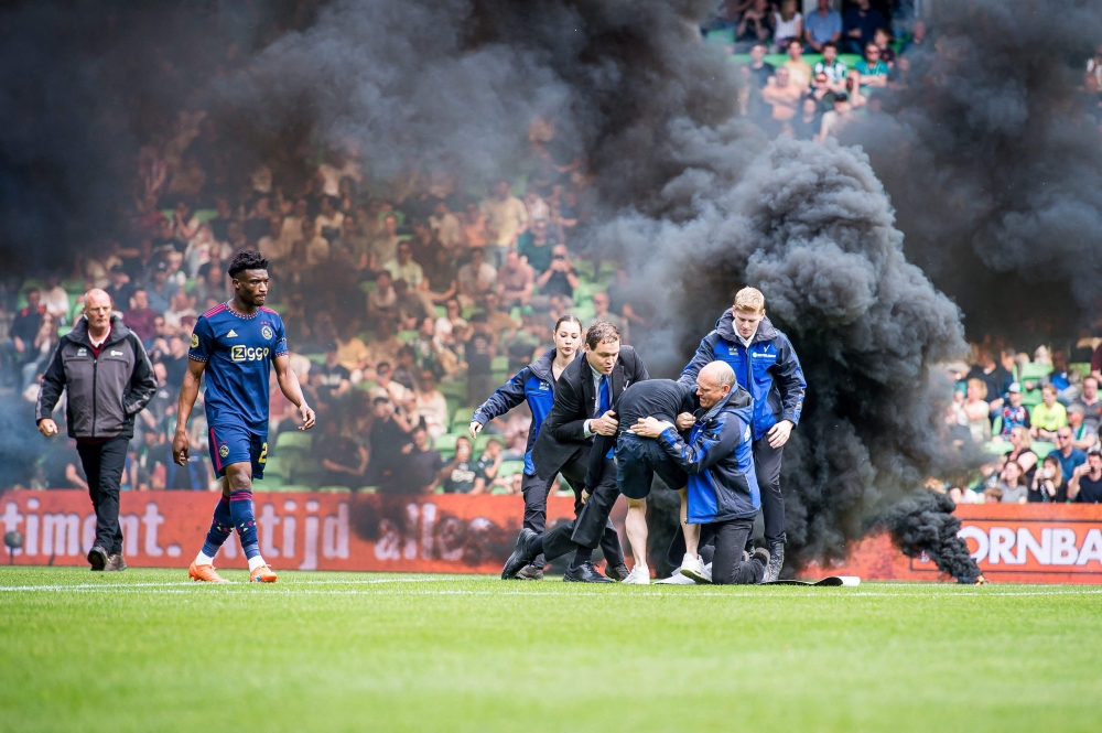 A supporter storms the field during the Dutch Premier league football match between FC Groningen and Ajax Amsterdam at the Euroborg stadium in Groeningen, on May 14, 2023 in Groningen. (Photo by Cor Lasker / various sources / AFP)