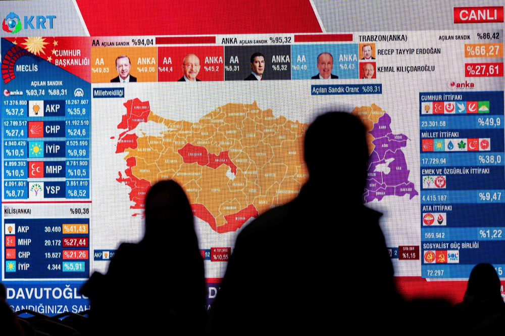 CHP members watch TV after the first results at the CHP building in Istanbul on May 14, 2023, after polls closed in Turkiye's presidential and parliamentary elections first round. Photo by Yasin AKGUL / AFP