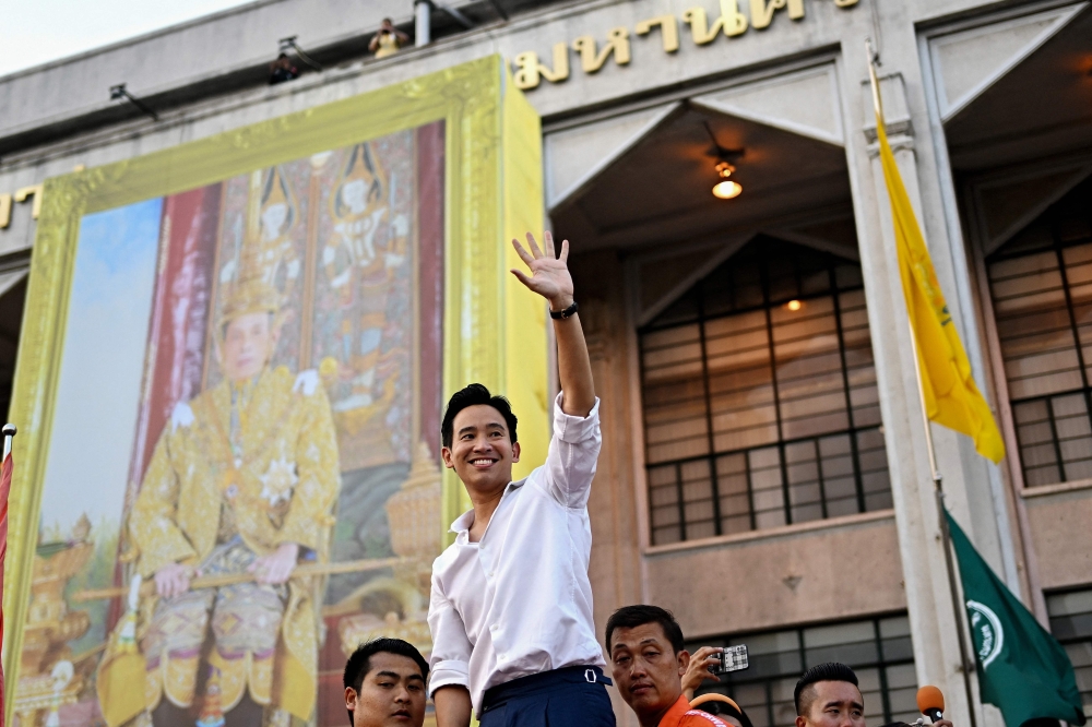 Move Forward Party leader and prime ministerial candidate Pita Limjaroenrat (C) waves to his supporters during a victory parade in Bangkok on May 15, 2023. (Photo by MANAN VATSYAYANA / AFP)