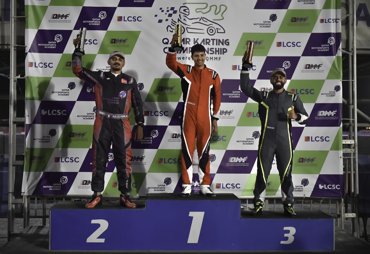 The 2023 Qatar Karting Championship winner Bader Al Sulaiti celebrates on the podium along with Faesal Al Yafei and Omar Aswat.  
Final 