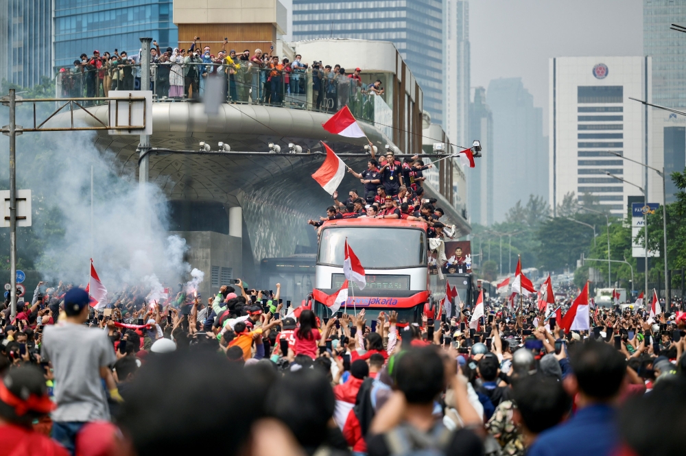Fans attend a victory parade for Indonesia's football team in Jakarta on May 19, 2023, after they won the gold medal in the men's event at the 32nd Southeast Asian Games (SEA Games) in Phnom Penh. (Photo by Bay Ismoyo / AFP)