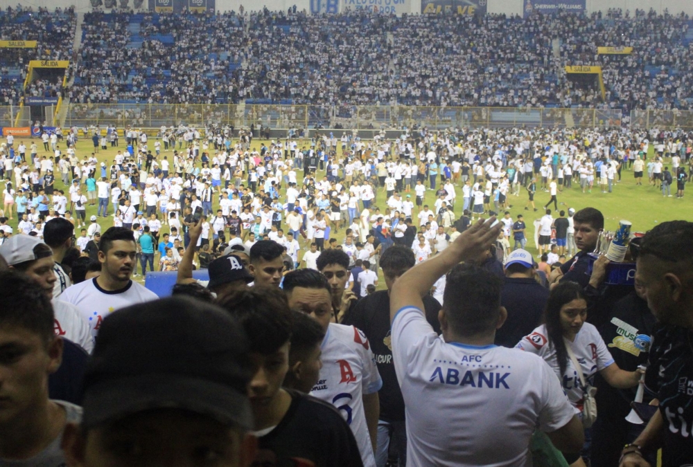 Fans invade the pitch following a stampede during a football match between Alianza and FAS at Cuscatlan stadium in San Salvador on May 20, 2023. Photo by Gabriel AQUINO / AFP