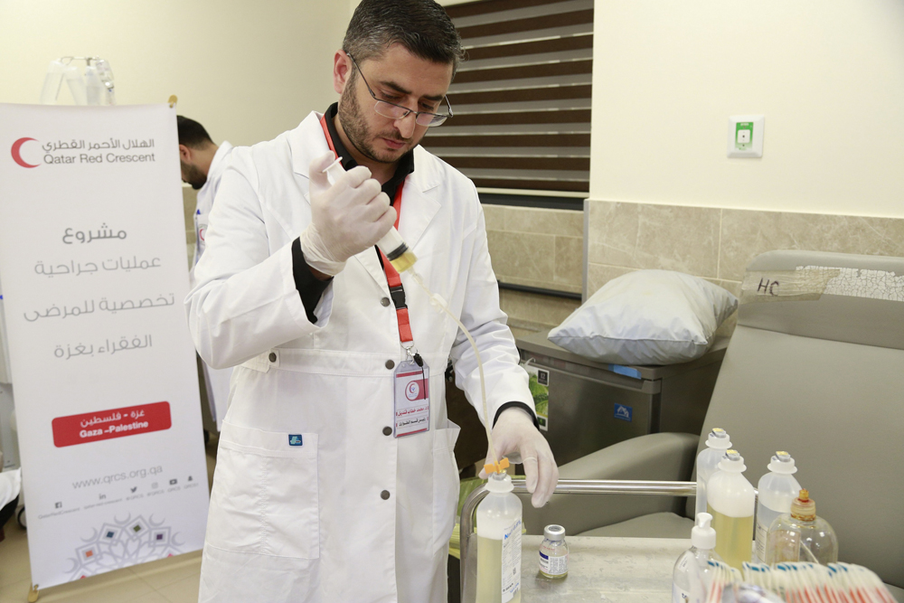 A QRCS doctor providing treatment in Gaza.