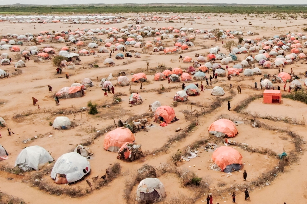 This aerial view shows makeshift structures of people displaced by drought at the Ladan internally displaced people (IDP) camp in Dolow on May 1, 2023. (Photo by Hassan Ali Elmi / AFP)
