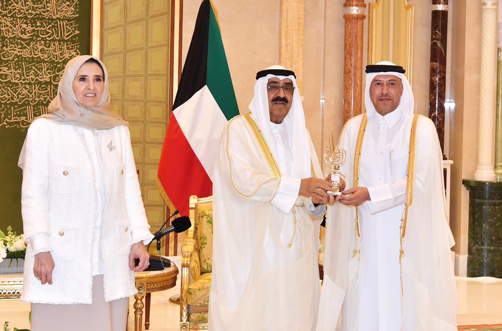 Crown Prince of the State of Kuwait H H Sheikh Mishaal Al Ahmad Al Jaber Al Sabah presenting the award to Attorney General H E Dr. Issa bin Saad Al Jafali Al Nuaimi.