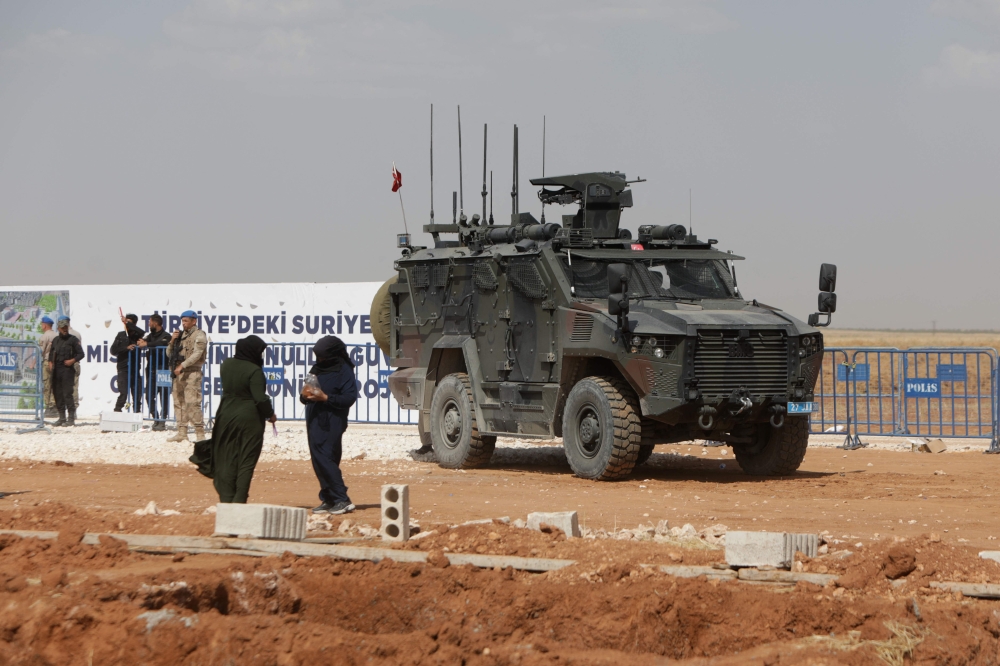 In this picture taken on May 24, 2023, a Turkish military vehicle is pictured during the inauguration of a Turkish-funded housing complex for the internally displaced, in the area of Ghandoura, in the Syrian countryside of Jarablus. (Photo by Bakr Alkasem / AFP)