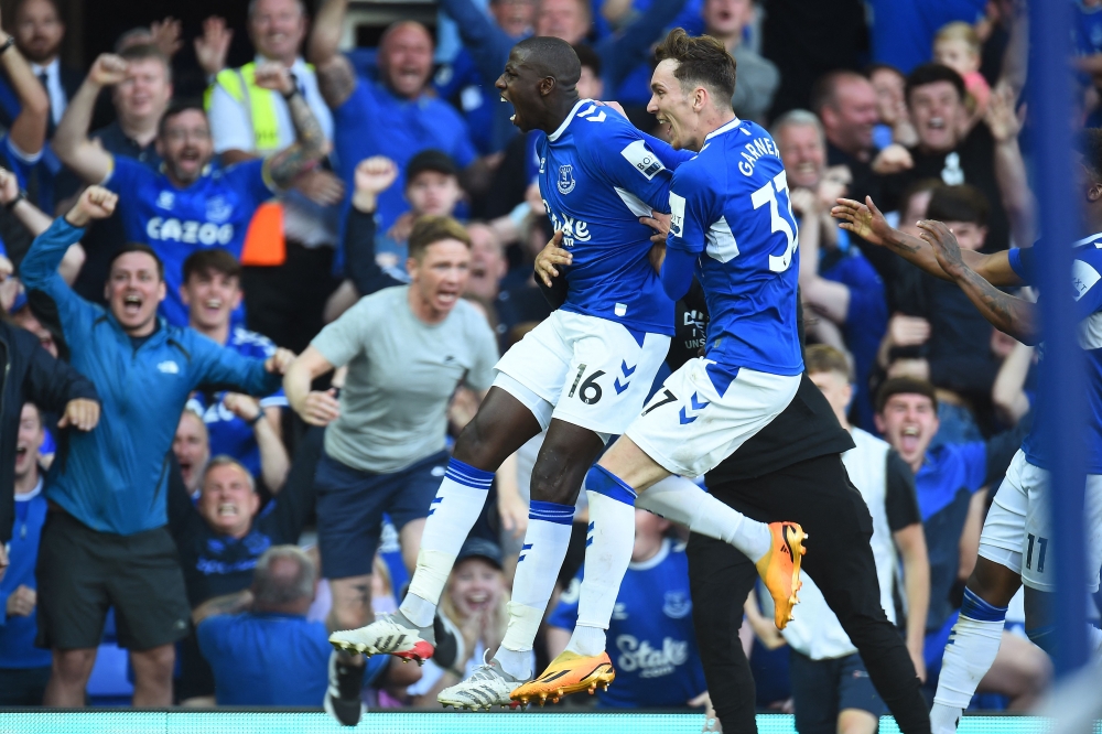 Everton's French midfielder Abdoulaye Doucoure (C) celebrates with teammates after scoring a goal during the English Premier League football match between Everton and Bournemouth at Goodison Park in Liverpool, northwest England, on May 28, 2023. (Photo by PETER POWELL / AFP) 


