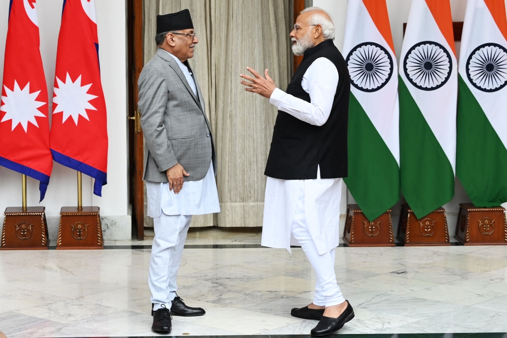 Indian Prime Minister Narendra Modi (right) and Nepal Prime Minister Pushpa Kamal Dahal talk before their meeting at Hyderabad House in New Delhi on June 1, 2023. (Photo by Sajjad Hussain / AFP)