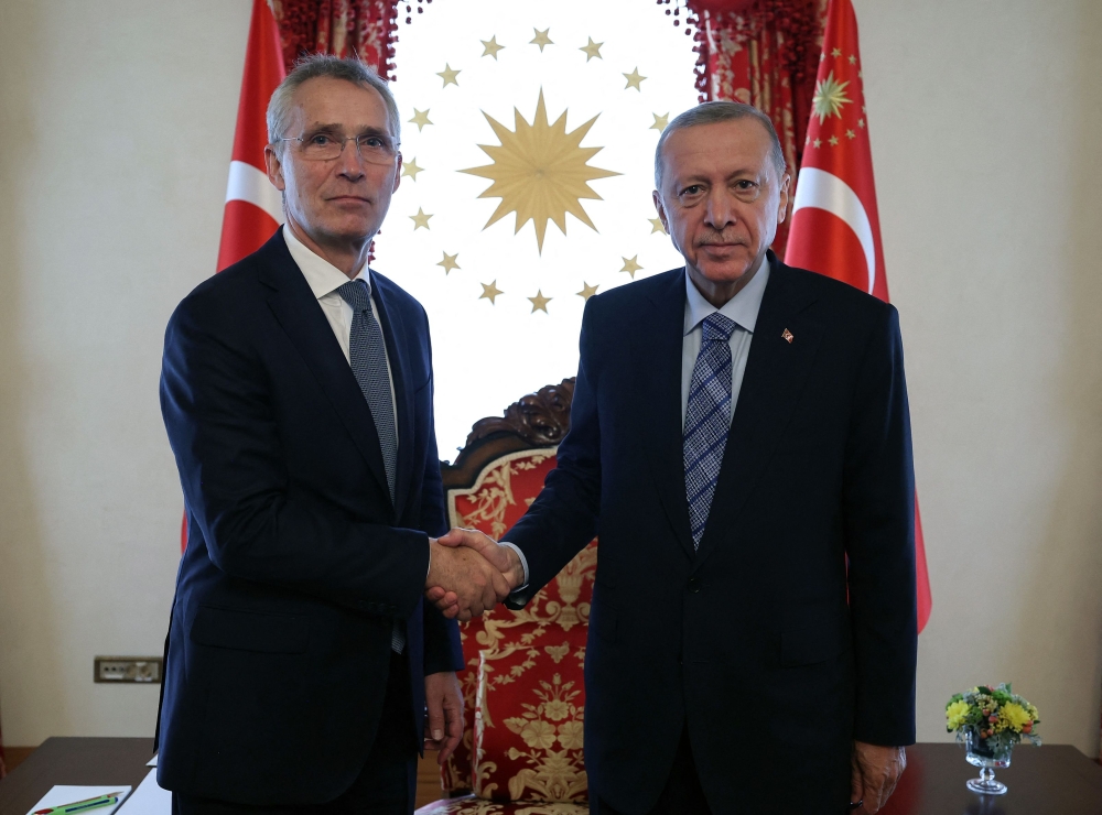 In this handout photograph taken and released by the Press Office of the Republic of Turkiye on June 4, 2023, Turkish President Recep Tayyip Erdogan (right) shakes hands with North Atlantic Treaty Organization (NATO) Secretary General Jens Stoltenberg at the Dolmabahce Office in Istanbul, Turkiye. (Photo by Handout / Press Office of the Presidency of Turkey / AFP)