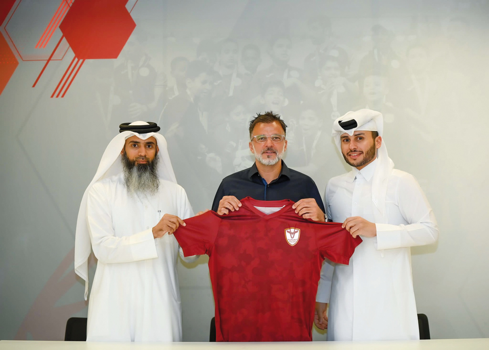 Anthony Hudson with Al Markhiya officials.