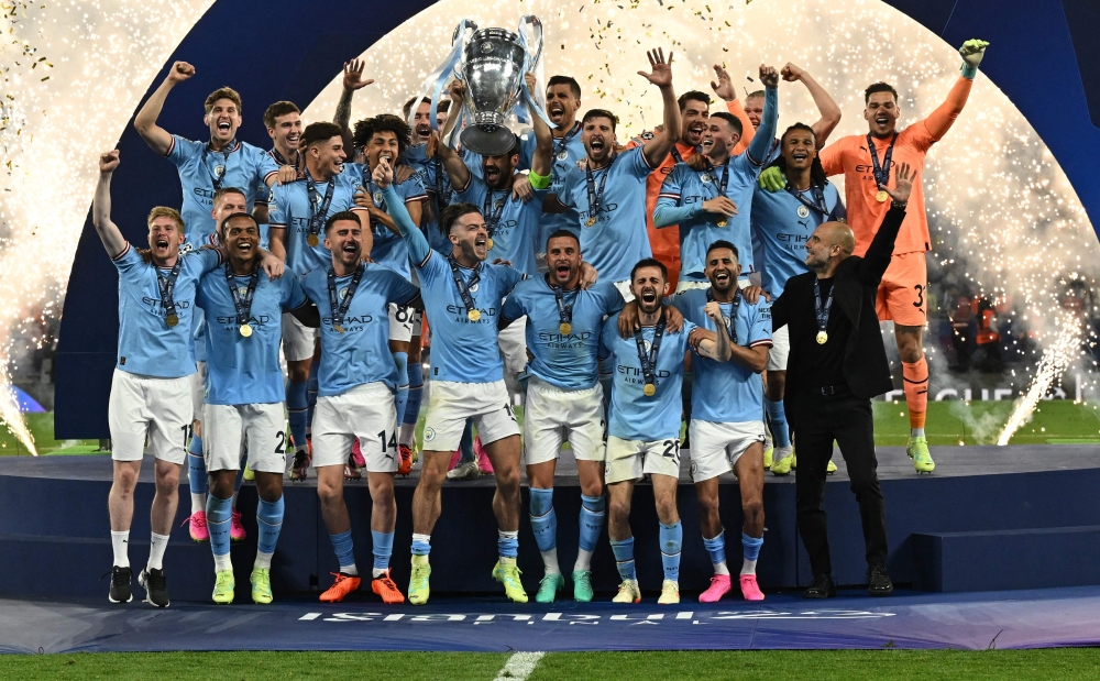 Manchester City's German midfielder #8 Ilkay Gundogan holds aloft the European Cup trophy as they celebrate winning the UEFA Champions League final football match between Inter Milan and Manchester City at the Ataturk Olympic Stadium in Istanbul, on June 10, 2023. (Photo by Paul ELLIS / AFP)