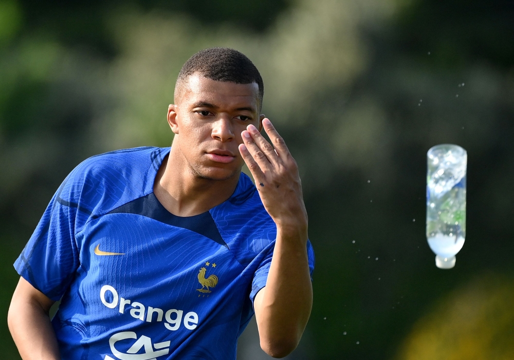 France's forward Kylian Mbappe throws a bottle during a training session ahead of the upcoming UEFA Euro 2024 football tournament qualifying matches in Clairefontaine-en-Yvelines, on June 12, 2023.  Photo by FRANCK FIFE / AFP