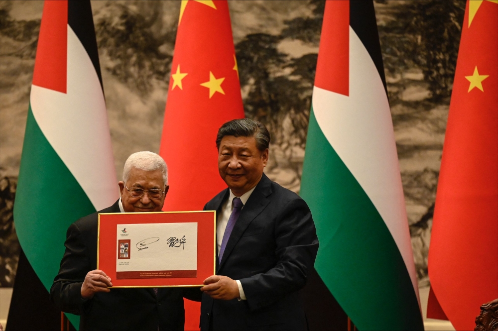 China's President Xi Jinping (right) and Palestinian President Mahmud Abbas attend a signing ceremony at the Great Hall of the People in Beijing on June 14, 2023. (Photo by Jade Gao / POOL / AFP)