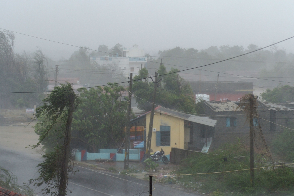 Heavy rain falls and strong winds blow through Mandvi town, some 100km southeast of Jakhau Port, on June 16, 2023, after cyclone Biparjoy made landfall. Photo by Sam PANTHAKY / AFP
