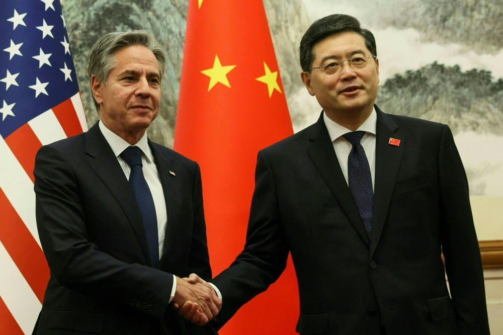 US Secretary of State Antony Blinken (L) and China's Foreign Minister Qin Gang shake hands ahead of a meeting at the Diaoyutai State Guesthouse in Beijing on June 18, 2023. (Photo by LEAH MILLIS / POOL / AFP)