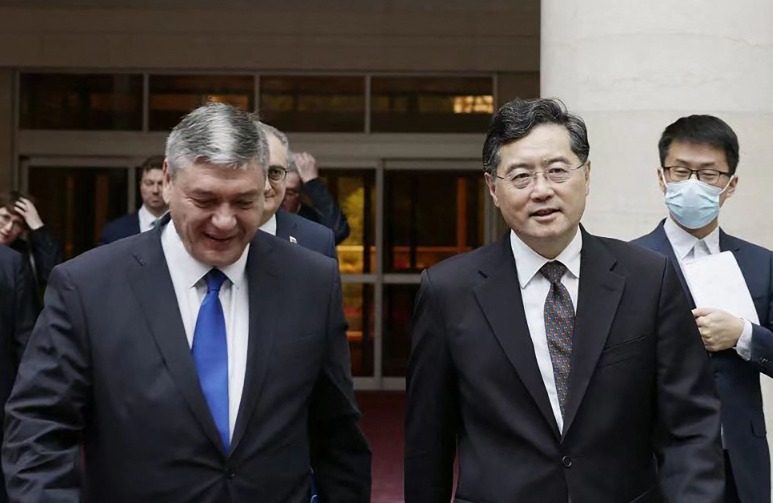 This handout picture taken and released by the Ministry of Foreign Affairs of the People's Republic of China on June 25, 2023 shows Russia's deputy foreign minister Andrey Rudenko (L) and China's Foreign Minister Qin Gang (R) walk together as they meet in Beijing. (Photo by Handout / Ministry of Foreign Affairs of the People's Republic of China / AFP)